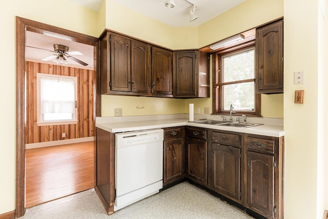 536 Center Ave, Sycamore, IL 60178 - kitchen with dishwasher, dark brown cabinets, light countertops, and wooden walls