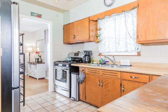 204 N Elroy Ave, Bartlett, IL 60103 - kitchen featuring appliances with stainless steel finishes, light countertops, tasteful backsplash, and brown cabinetry