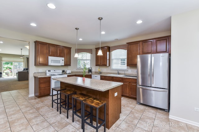 2065 John Paul Jones Ln Unit 2065, Bolingbrook, IL 60490 - kitchen with white appliances, recessed lighting, light tile patterned flooring, a kitchen breakfast bar, and a center island