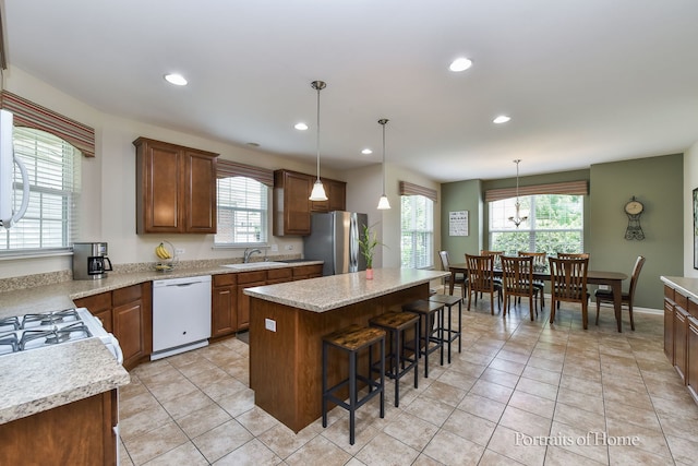 2065 John Paul Jones Ln Unit 2065, Bolingbrook, IL 60490 - kitchen with white appliances, plenty of natural light, a kitchen breakfast bar, recessed lighting, and a kitchen island