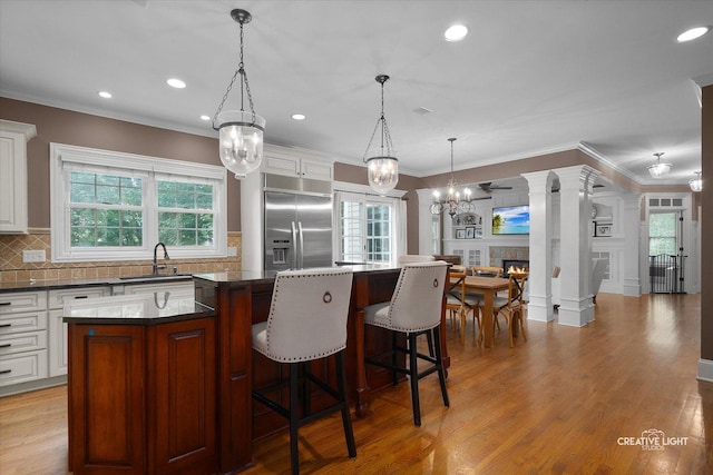 3704 Heathmoor Dr, Elgin, IL 60124 - kitchen featuring stainless steel built in fridge, a center island, decorative backsplash, dark countertops, and recessed lighting