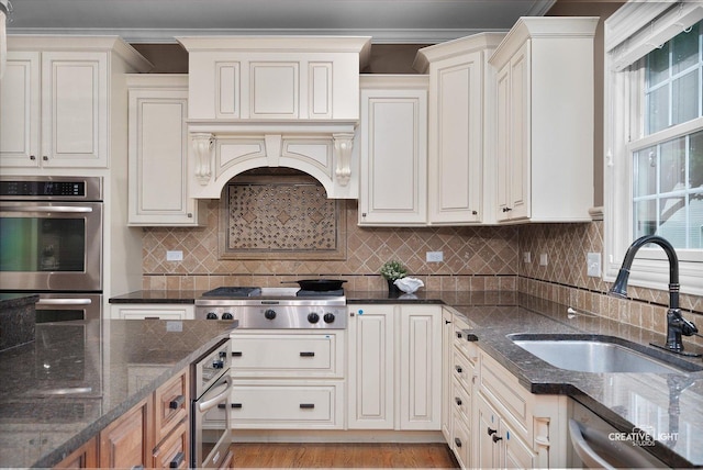3704 Heathmoor Dr, Elgin, IL 60124 - kitchen featuring stainless steel appliances, dark stone countertops, decorative backsplash, and light wood finished floors