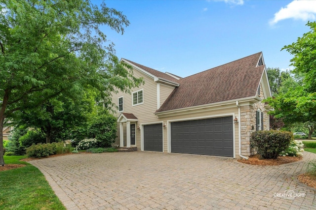 3704 Heathmoor Dr, Elgin, IL 60124 - traditional-style house featuring a shingled roof, stone siding, a garage, and driveway