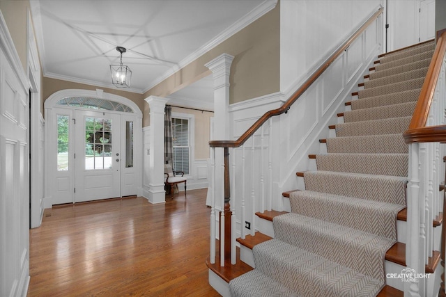 3704 Heathmoor Dr, Elgin, IL 60124 - foyer entrance with ornate columns, stairway, a decorative wall, ornamental molding, and wood finished floors
