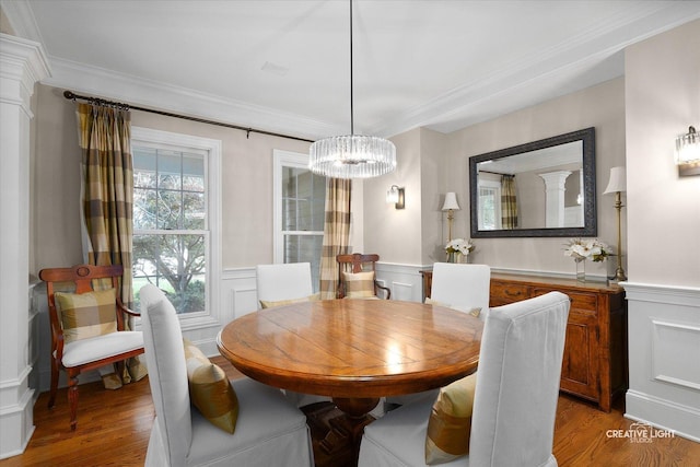 3704 Heathmoor Dr, Elgin, IL 60124 - dining area featuring a chandelier, light wood-type flooring, crown molding, a wainscoted wall, and a decorative wall