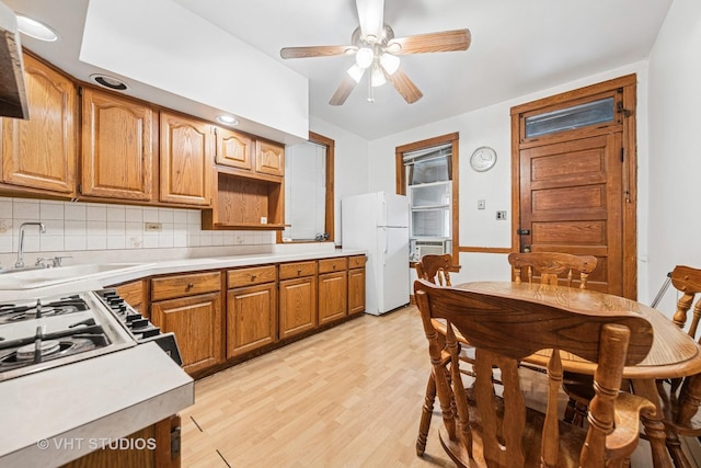 925 W 31st St, Chicago, IL 60608 - kitchen with freestanding refrigerator, backsplash, light wood-type flooring, light countertops, and a ceiling fan