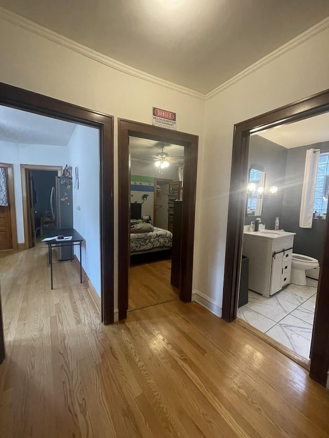 2918 N Normandy Ave, Chicago, IL 60634 - corridor featuring light wood finished floors and crown molding