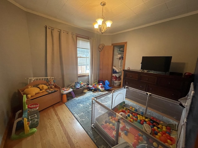 2918 N Normandy Ave, Chicago, IL 60634 - bedroom with wood finished floors, crown molding, and a chandelier