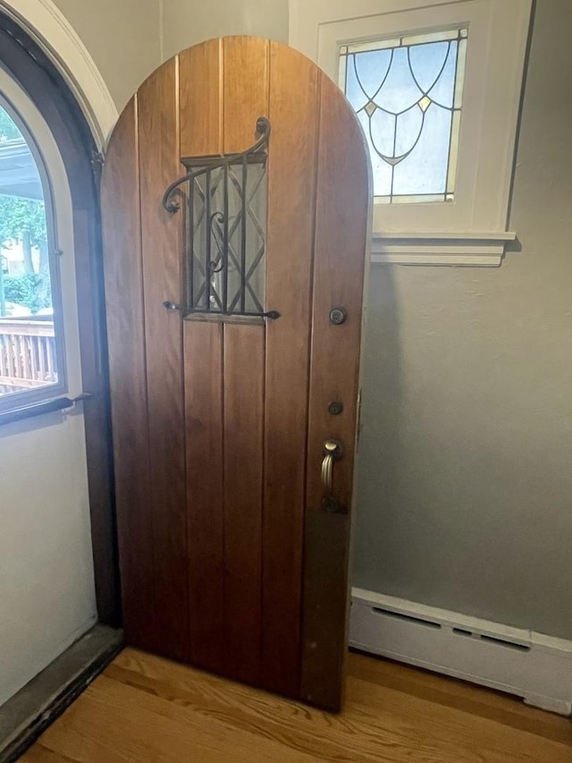 2918 N Normandy Ave, Chicago, IL 60634 - detailed view of a baseboard heating unit, wood finished floors, and arched walkways