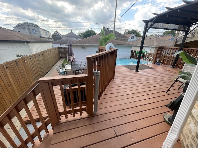 2918 N Normandy Ave, Chicago, IL 60634 - deck featuring outdoor dining space, a fenced backyard, a residential view, and an outbuilding