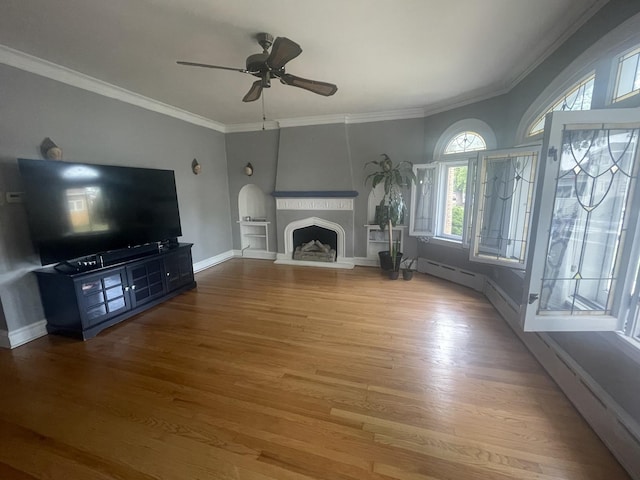 2918 N Normandy Ave, Chicago, IL 60634 - unfurnished living room featuring wood finished floors, crown molding, ceiling fan, and a fireplace with raised hearth