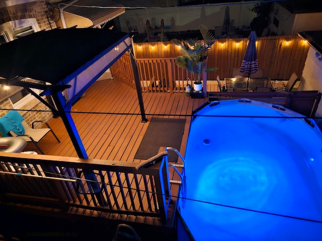 2918 N Normandy Ave, Chicago, IL 60634 - pool at twilight featuring a hot tub, outdoor dining space, and a deck
