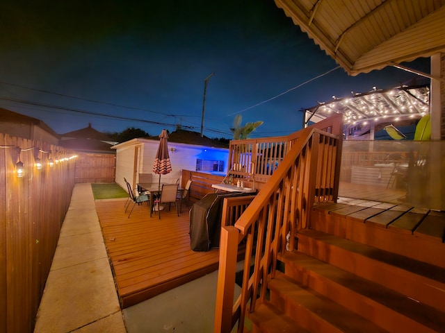 2918 N Normandy Ave, Chicago, IL 60634 - deck at night with outdoor dining space and a fenced backyard