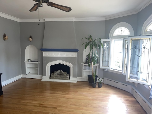 2918 N Normandy Ave, Chicago, IL 60634 - unfurnished living room featuring ceiling fan, wood finished floors, ornamental molding, a large fireplace, and a baseboard radiator