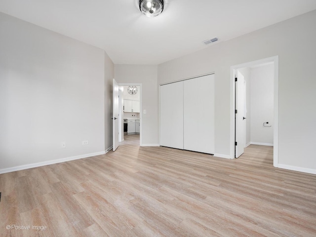 2804 River Bend Ln, Plainfield, IL 60586 - unfurnished bedroom featuring light wood-style floors and a closet