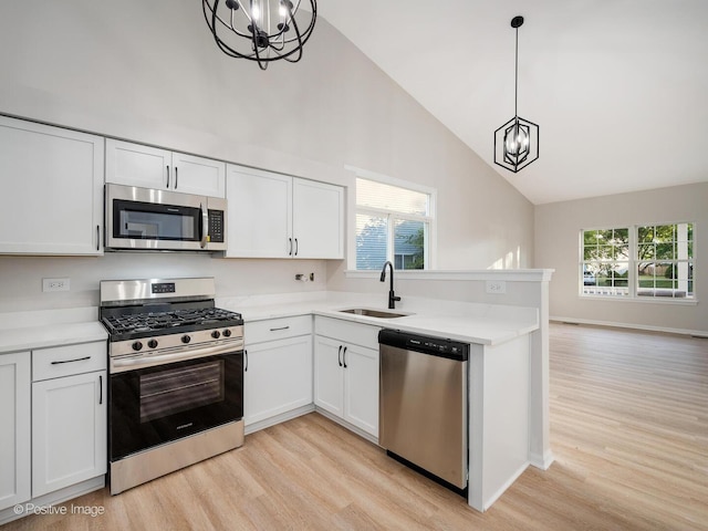2804 River Bend Ln, Plainfield, IL 60586 - kitchen featuring stainless steel appliances, a chandelier, light wood finished floors, light countertops, and high vaulted ceiling