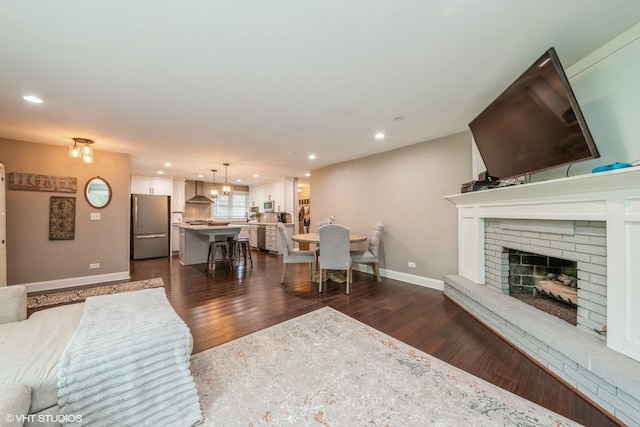 1715 Chesterfield Ave, Glen Ellyn, IL 60137 - living room featuring dark wood-style floors, a fireplace, recessed lighting, and a chandelier
