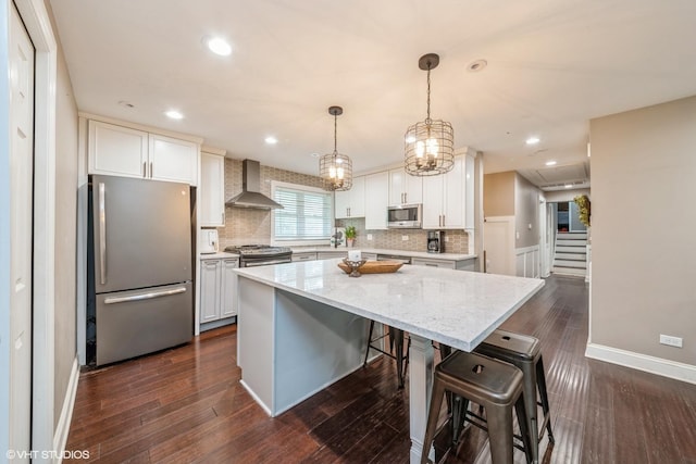 1715 Chesterfield Ave, Glen Ellyn, IL 60137 - kitchen with stainless steel appliances, wall chimney range hood, backsplash, a center island, and light stone counters