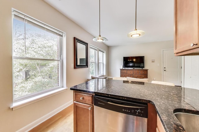 3005 N Clifton Ave Unit 201, Chicago, IL 60657 - kitchen with dishwasher, dark stone countertops, light wood finished floors, and pendant lighting