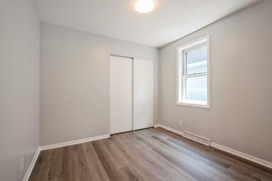3131 N Odell Ave, Chicago, IL 60707 - unfurnished bedroom featuring wood finished floors and a closet