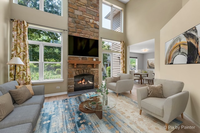 1521 E Baronet Ln, Palatine, IL 60074 - living room featuring wood finished floors, a fireplace, and a towering ceiling