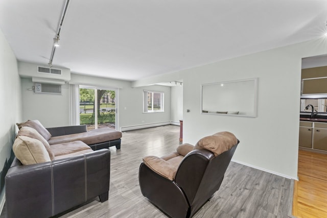 2319 E Olive St Unit 1D, Arlington Heights, IL 60004 - living area with a baseboard heating unit, track lighting, and light wood finished floors