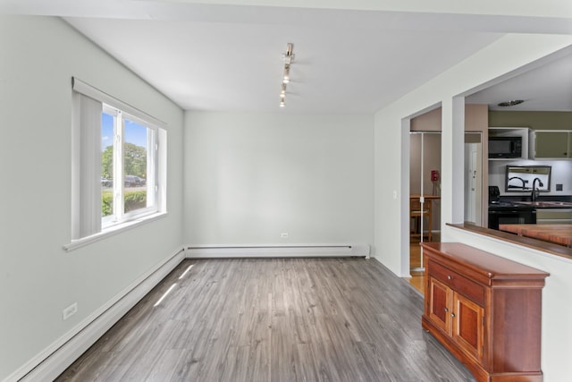 2319 E Olive St Unit 1D, Arlington Heights, IL 60004 - unfurnished dining area with a baseboard radiator, track lighting, and wood finished floors