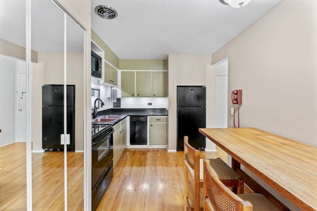 2319 E Olive St Unit 1D, Arlington Heights, IL 60004 - kitchen featuring black appliances, light wood-type flooring, and dark countertops