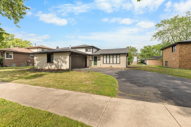 225 S Willow St, Glenwood, IL 60425 - view of front facade with an attached garage, brick siding, asphalt driveway, and a front lawn