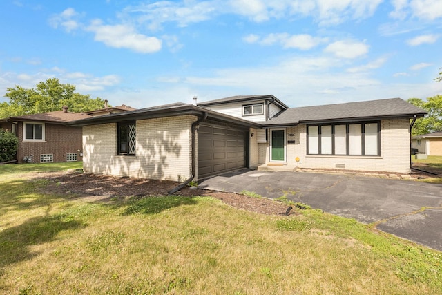225 S Willow St, Glenwood, IL 60425 - tri-level home with an attached garage, brick siding, driveway, and a front lawn