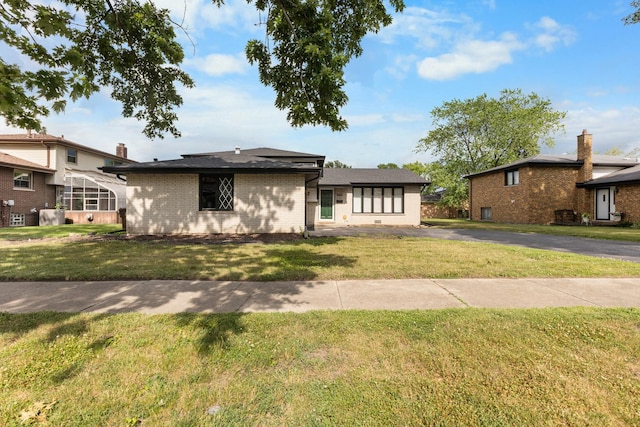 225 S Willow St, Glenwood, IL 60425 - view of front facade featuring a front lawn and brick siding