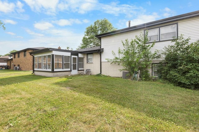 225 S Willow St, Glenwood, IL 60425 - rear view of house with a yard and brick siding