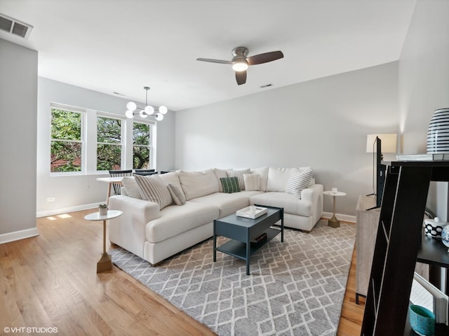 3607 N Bosworth Ave Unit 3, Chicago, IL 60613 - living area featuring ceiling fan, light wood-style flooring, and a chandelier