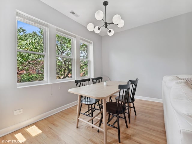 3607 N Bosworth Ave Unit 3, Chicago, IL 60613 - dining space featuring a chandelier and light wood-style flooring