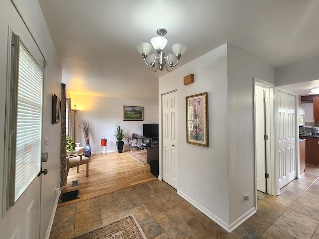 72 Wilton Ln, Mundelein, IL 60060 - corridor with light stone finish flooring and a chandelier