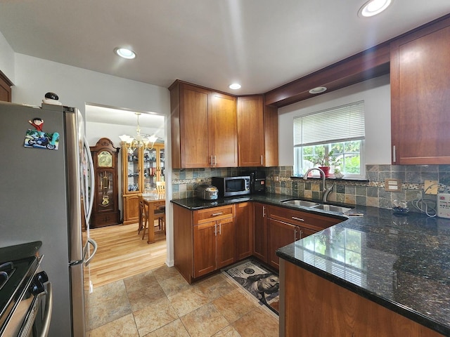 72 Wilton Ln, Mundelein, IL 60060 - kitchen featuring appliances with stainless steel finishes, a chandelier, backsplash, dark stone countertops, and recessed lighting