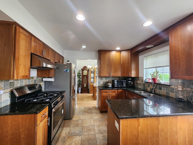 72 Wilton Ln, Mundelein, IL 60060 - kitchen featuring stainless steel appliances, under cabinet range hood, backsplash, a peninsula, and brown cabinets