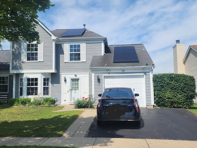 72 Wilton Ln, Mundelein, IL 60060 - view of front of house with a garage, solar panels, asphalt driveway, a front lawn, and roof with shingles