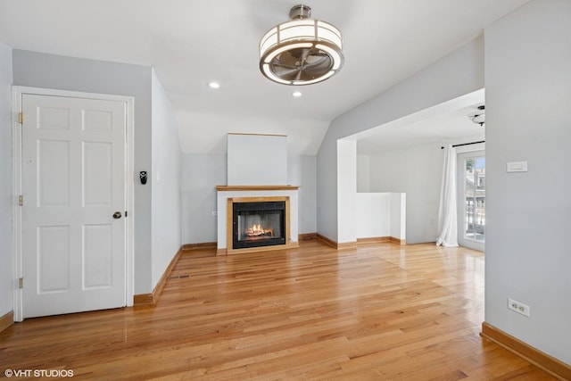 3012 N Nottingham Ave, Chicago, IL 60634 - unfurnished living room featuring light wood-type flooring, a glass covered fireplace, and recessed lighting
