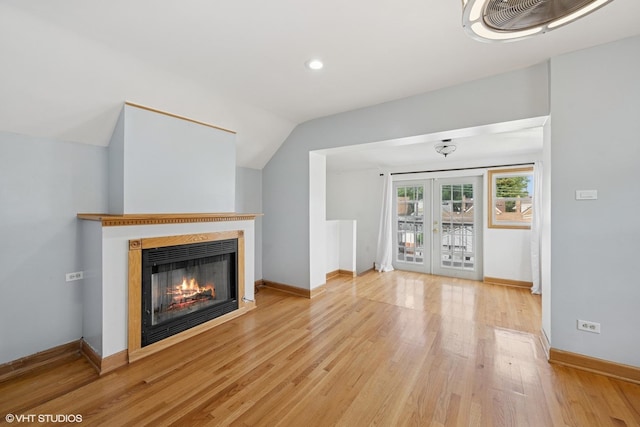 3012 N Nottingham Ave, Chicago, IL 60634 - unfurnished living room featuring a glass covered fireplace, french doors, light wood-style floors, lofted ceiling, and recessed lighting