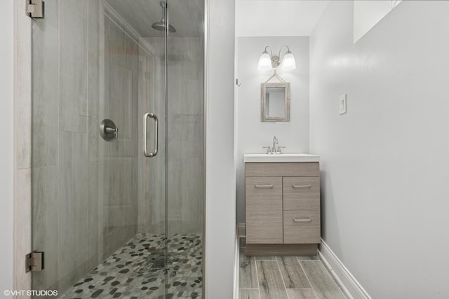 3012 N Nottingham Ave, Chicago, IL 60634 - bathroom featuring vanity, a shower stall, and wood finished floors