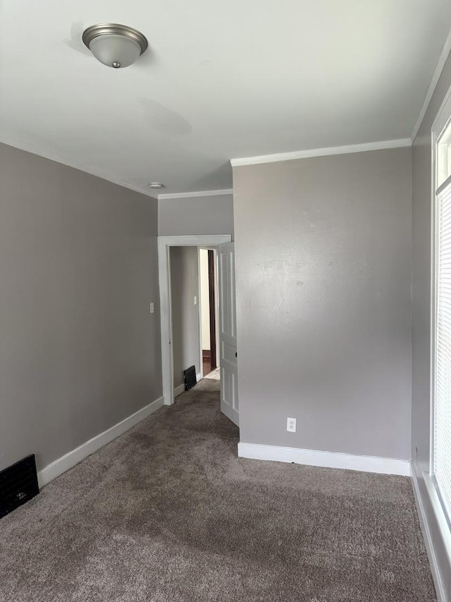 118 Wilcox Ave, Elgin, IL 60123 - spare room with dark colored carpet and crown molding