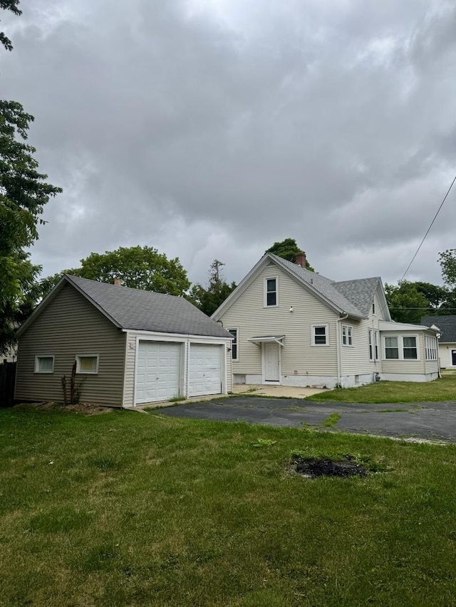 118 Wilcox Ave, Elgin, IL 60123 - view of side of property featuring a chimney, an outdoor structure, and a yard
