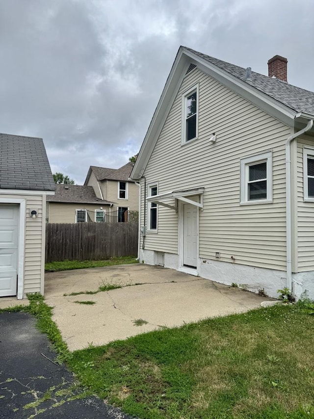 118 Wilcox Ave, Elgin, IL 60123 - back of house with a chimney and a patio