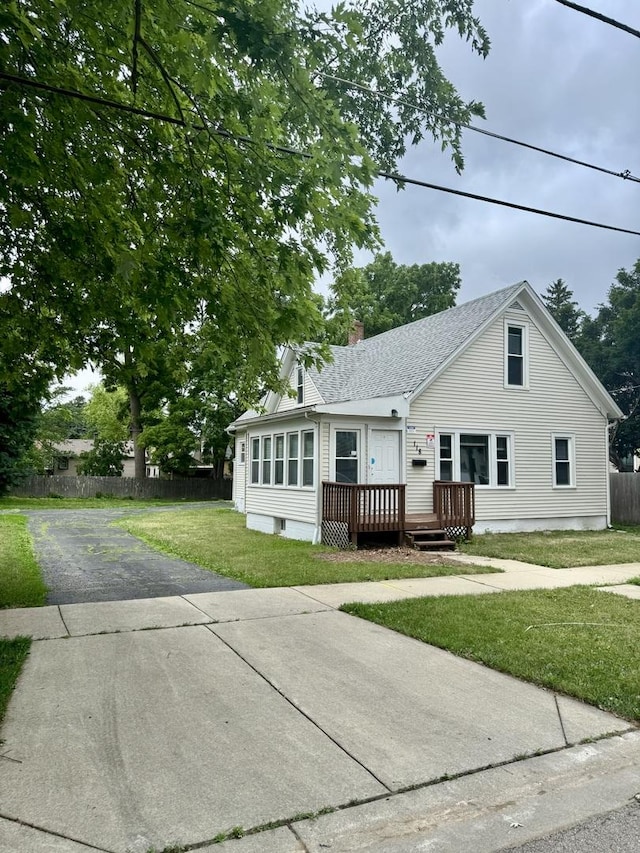 118 Wilcox Ave, Elgin, IL 60123 - view of front facade featuring a deck, a chimney, and a shingled roof
