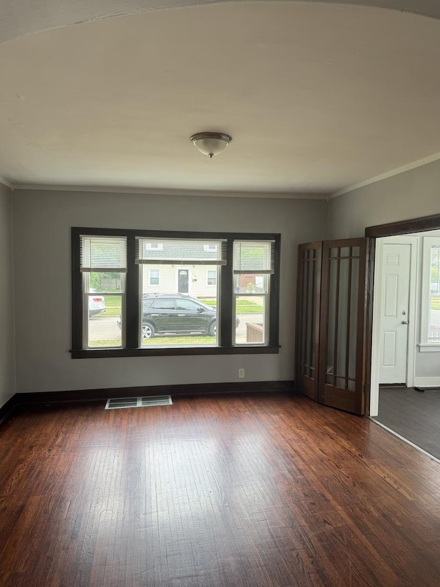 118 Wilcox Ave, Elgin, IL 60123 - empty room with dark wood-type flooring and ornamental molding