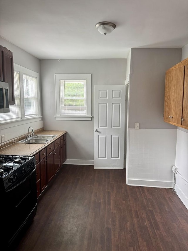 118 Wilcox Ave, Elgin, IL 60123 - kitchen featuring black gas range oven, dark wood-type flooring, stainless steel microwave, and light countertops