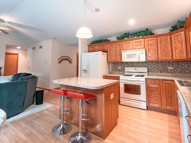 967 Brown Dr, Momence, IL 60954 - kitchen with white appliances, open floor plan, light wood finished floors, a center island, and ceiling fan