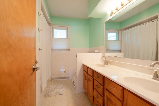 14 Grandview Dr, Normal, IL 61761 - full bathroom featuring double vanity, wainscoting, and tile walls