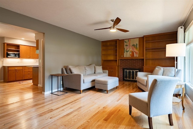 14 Grandview Dr, Normal, IL 61761 - living room with ceiling fan, light wood-style flooring, and a fireplace